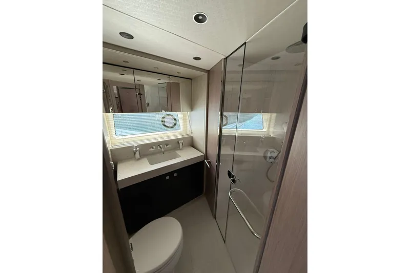 Svetlana Yacht Photos Pics Luxurious bathroom in 2025 Sunseeker 76 Yacht with modern fixtures and glass shower.