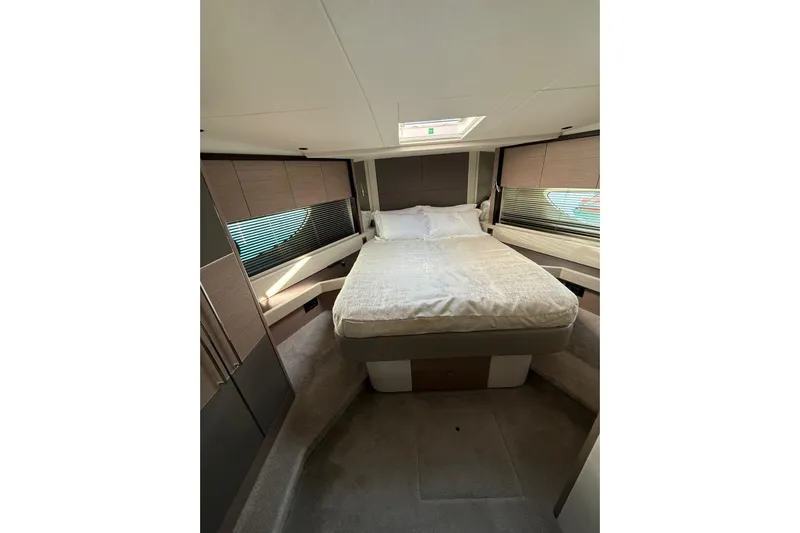 Svetlana Yacht Photos Pics Luxurious bedroom interior of 2025 Sunseeker 76 Yacht with modern design and cozy bedding.