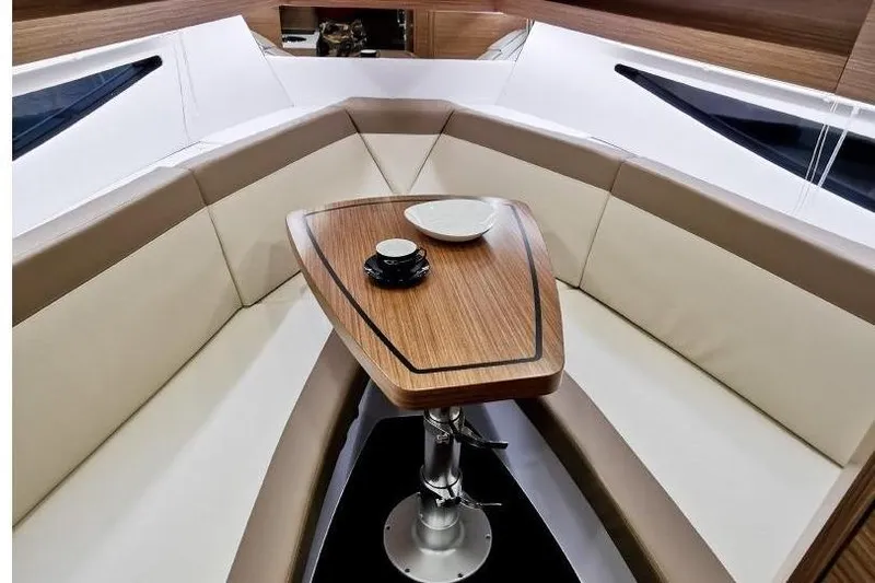 Custom Order Your 28 Scl Today! Yacht Photos Pics Luxurious interior of 2026 Cobrey 28 SC yacht with elegant seating and wooden table.