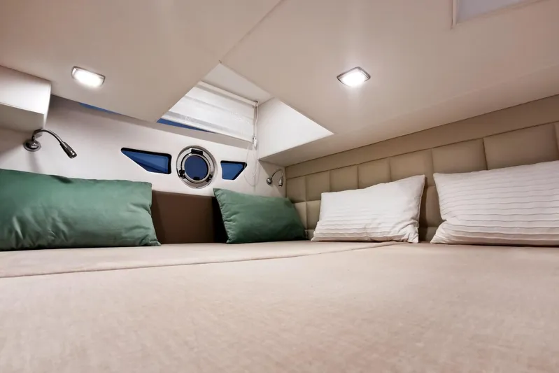 Custom Order Your 28 Scl Today! Yacht Photos Pics Luxurious cabin interior of 2026 Cobrey 28 SC yacht with cozy bedding.