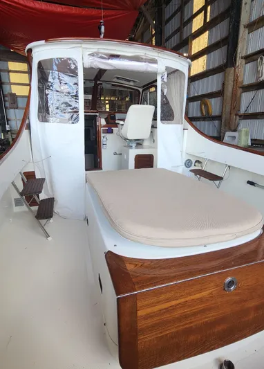 Stardust Yacht Photos Pics 1996 Hinckley Picnic Boat interior with seating and wooden accents in a storage shed.