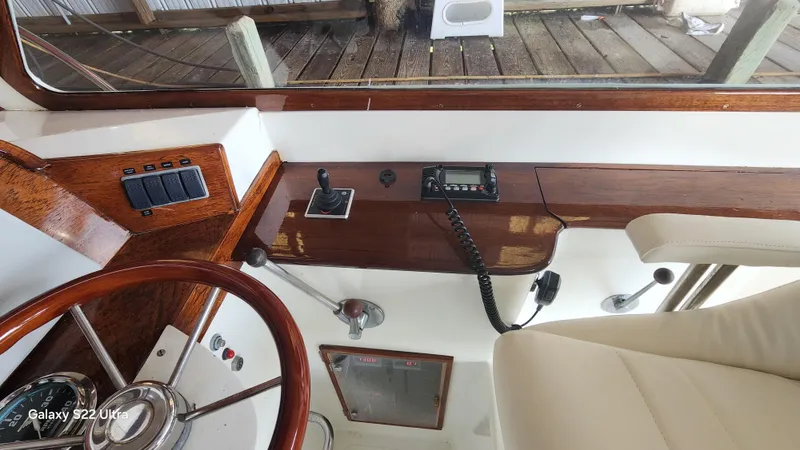 Stardust Yacht Photos Pics Interior of a 1996 Hinckley Picnic Boat showing steering wheel and control panel.