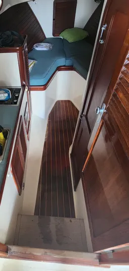 Stardust Yacht Photos Pics Interior of a 1996 Hinckley Picnic Boat with wooden flooring and cozy seating area.