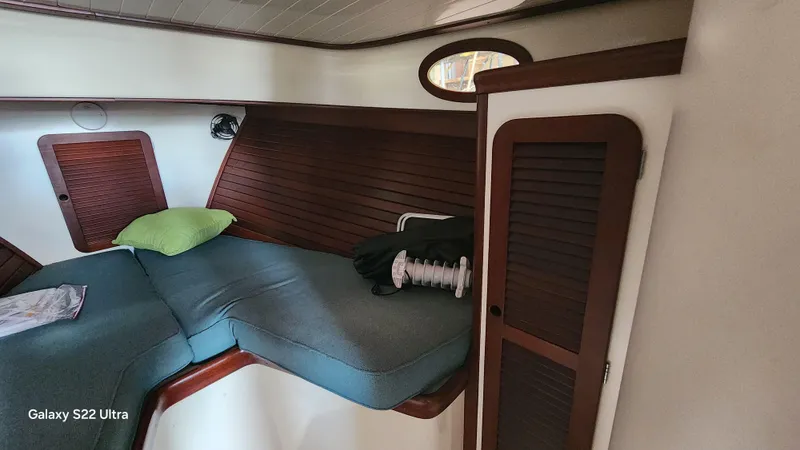 Stardust Yacht Photos Pics Cozy cabin interior of a 1996 Hinckley Picnic Boat with wooden accents and cushions.