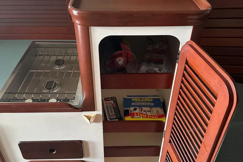 Stardust Yacht Photos Pics Hinckley Picnic Boat 1996 interior with stove and storage cabinet.