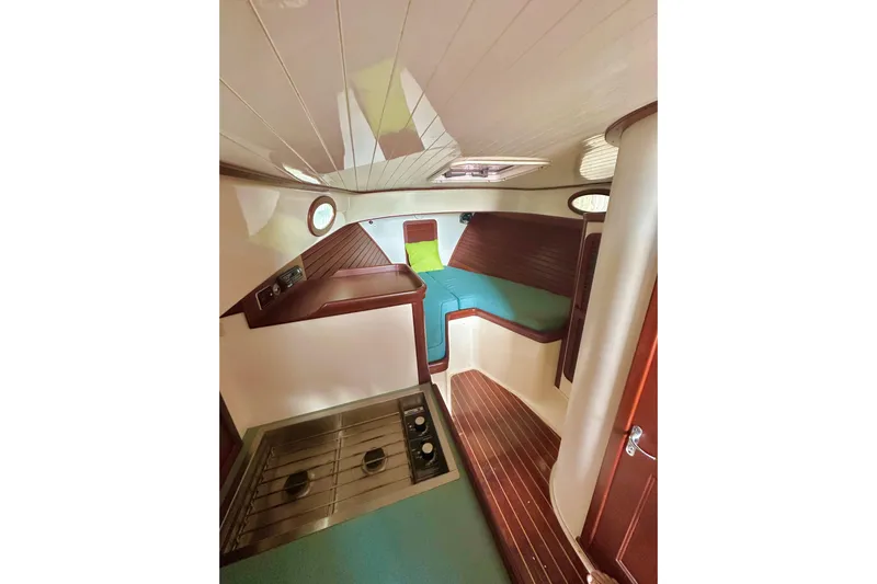 Stardust Yacht Photos Pics Interior of a 1996 Hinckley Picnic Boat with cozy seating and compact kitchen area.