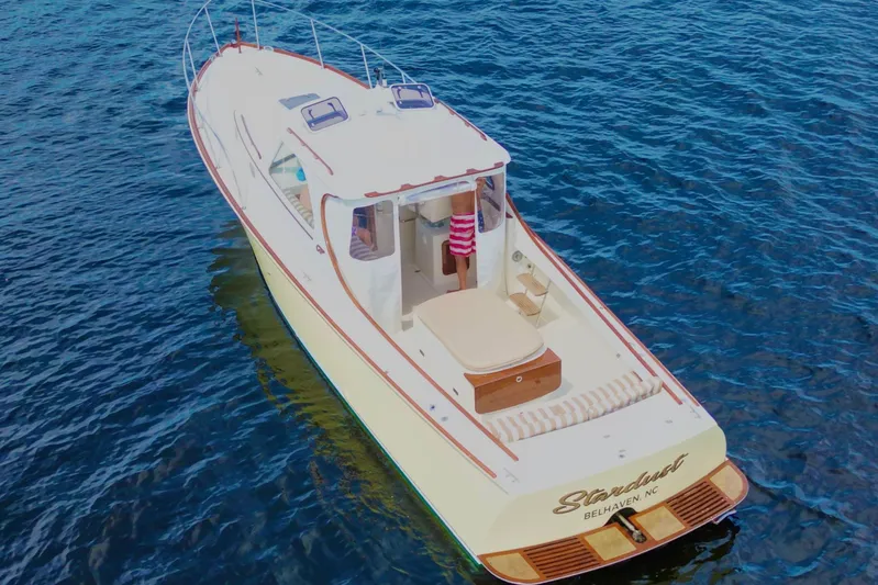 Stardust Yacht Photos Pics 1996 Hinckley Picnic Boat on blue water, featuring elegant design and comfortable seating.