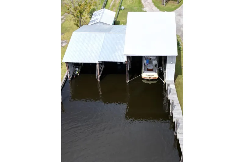 Stardust Yacht Photos Pics Aerial view of 1996 Hinckley Picnic Boat docked in a covered boathouse.