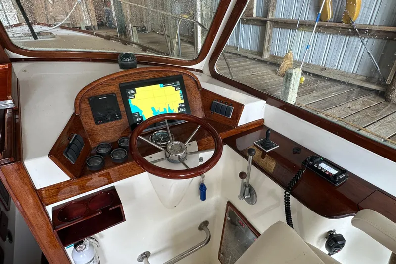 Stardust Yacht Photos Pics 1996 Hinckley Picnic Boat helm with wooden accents and navigation equipment.