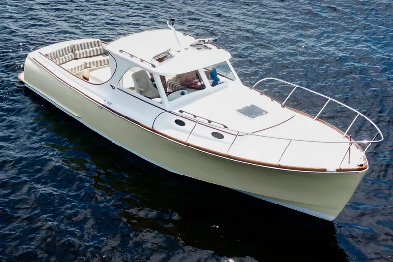 Stardust Yacht Photos Pics 1996 Hinckley Picnic Boat cruising on open water, featuring elegant design and classic style.