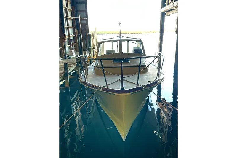 Stardust Yacht Photos Pics 1996 Hinckley Picnic Boat docked in a boathouse, front view.