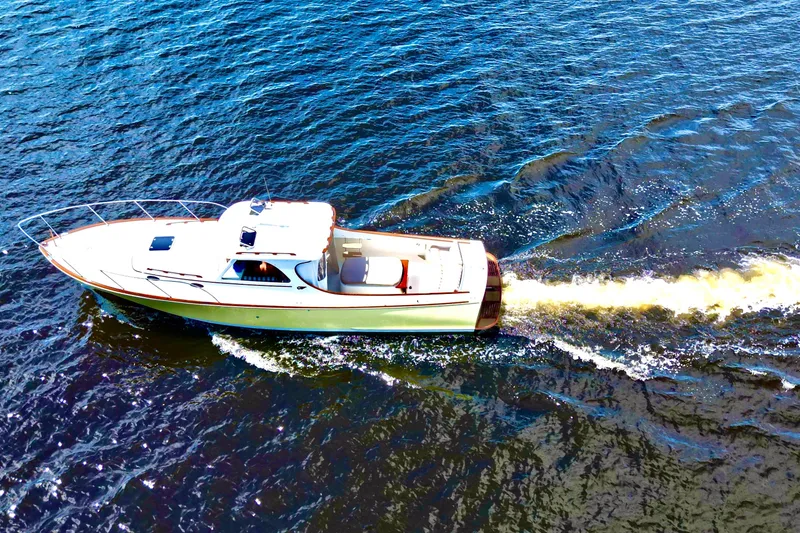 Stardust Yacht Photos Pics 1996 Hinckley Picnic Boat cruising on open water, aerial view.