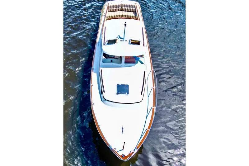 Stardust Yacht Photos Pics 1996 Hinckley Picnic Boat cruising on water, aerial view.