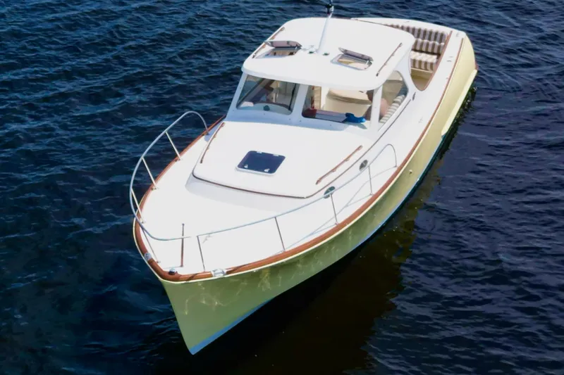 Stardust Yacht Photos Pics 1996 Hinckley Picnic Boat cruising on calm blue waters.