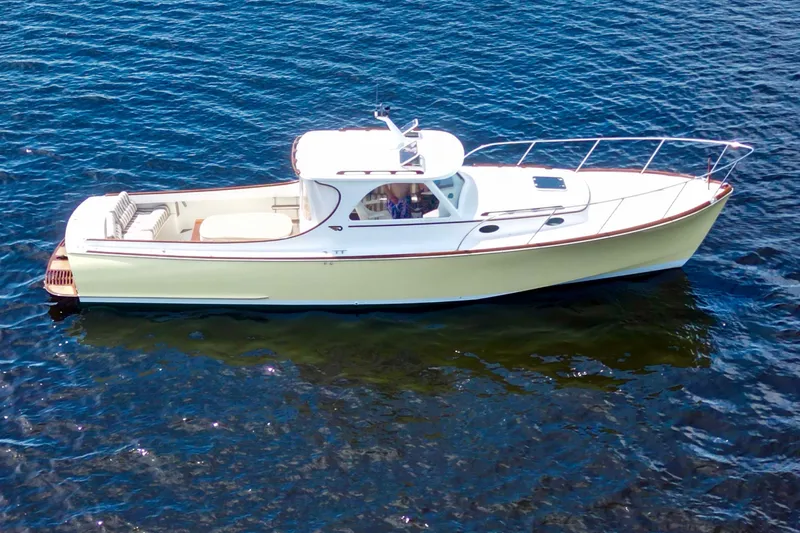 Stardust Yacht Photos Pics 1996 Hinckley Picnic Boat cruising on calm blue waters.