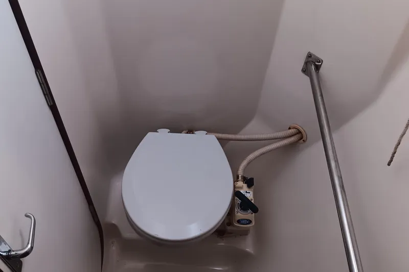 Heart Of Gold Yacht Photos Pics Marine toilet in a 1998 Hunter 450 sailboat bathroom with handrail and plumbing.
