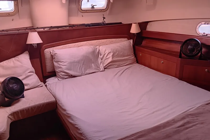 Heart Of Gold Yacht Photos Pics Cozy cabin interior of 1998 Hunter 450 yacht with bed, lamps, and fans.