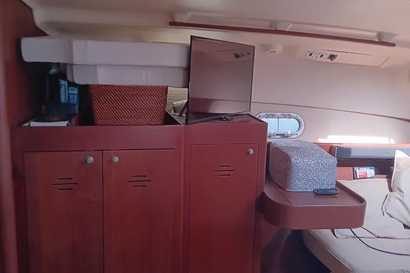 Heart Of Gold Yacht Photos Pics Interior of a 1998 Hunter 450 yacht with wooden cabinets and cozy seating area.