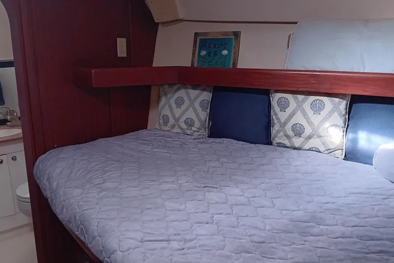 Heart Of Gold Yacht Photos Pics Cozy cabin interior of 1998 Hunter 450 yacht with bed and nautical decor.