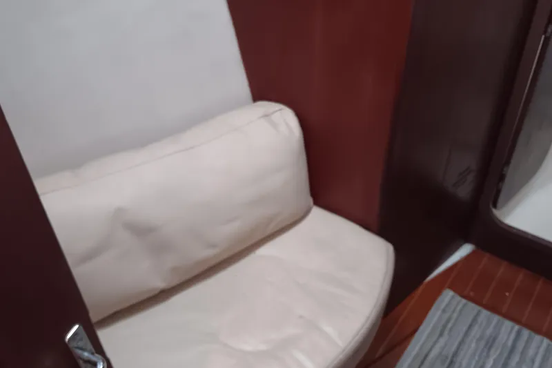 Heart Of Gold Yacht Photos Pics Interior seating area of a 1998 Hunter 450 yacht with white cushion.