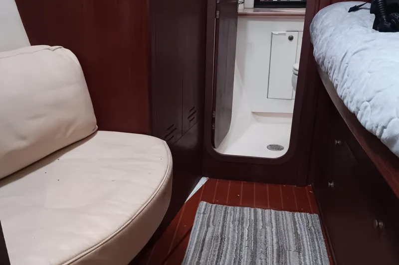 Heart Of Gold Yacht Photos Pics Interior of 1998 Hunter 450 yacht with seating, bed, and bathroom view.