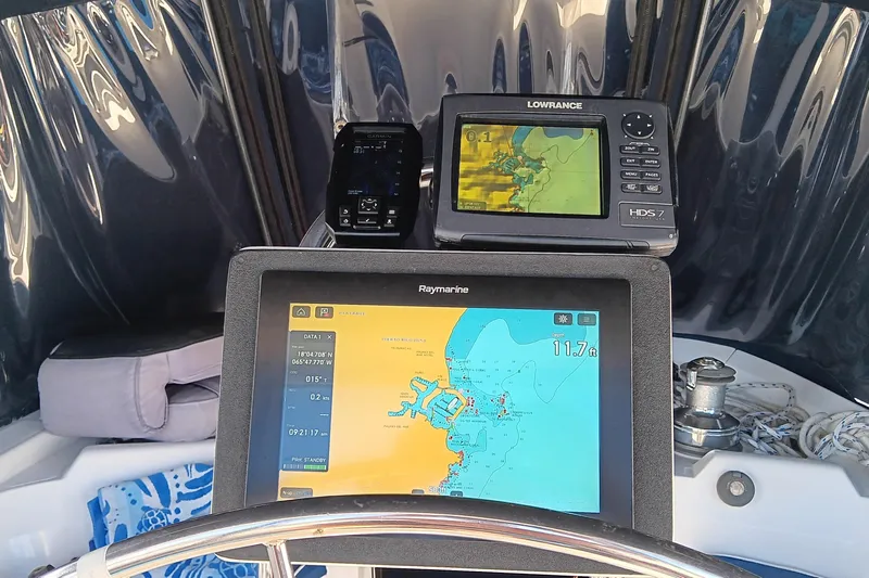 Heart Of Gold Yacht Photos Pics Navigation equipment on a 1998 Hunter 450 sailboat, featuring Raymarine and Lowrance displays.