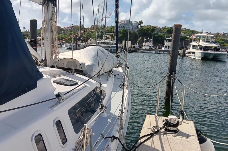 Heart Of Gold Yacht Photos Pics Sailboat docked at marina, Hunter 450 model, 1998, with clear skies and calm waters.