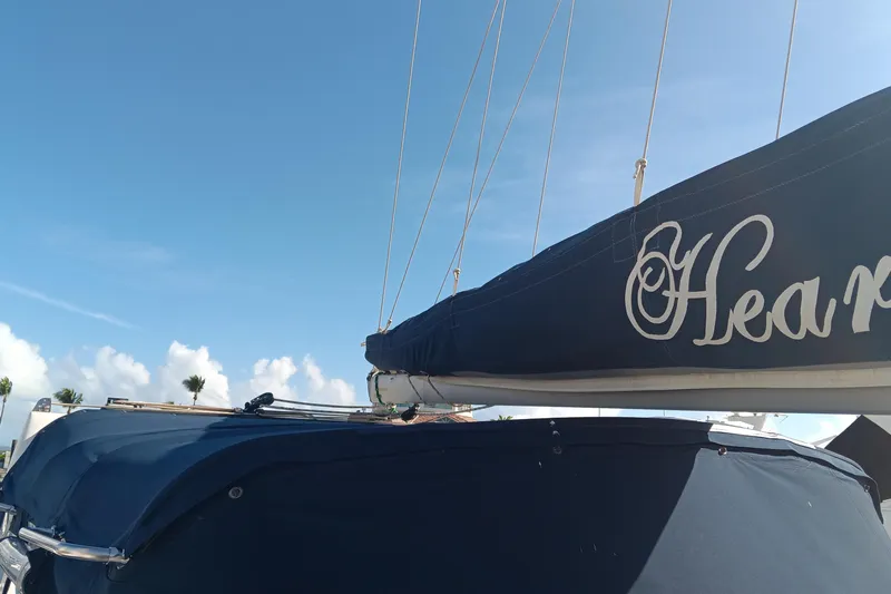 Heart Of Gold Yacht Photos Pics Sailboat with blue cover, Hunter 450 model, 1998, under clear blue sky.