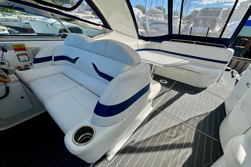  Yacht Photos Pics 2007 Formula 400 Super Sport boat interior with white seating and table, docked at marina.