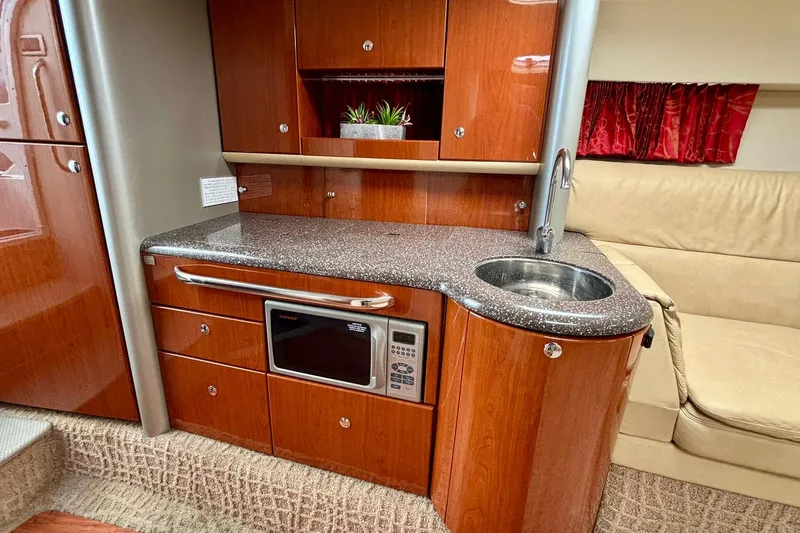  Yacht Photos Pics Luxurious 2007 Formula 400 Super Sport yacht interior with kitchenette and seating area.