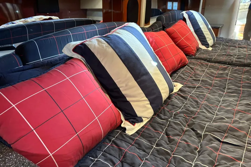  Yacht Photos Pics Interior of 2007 Formula 400 Super Sport with striped and checkered pillows on a bed.