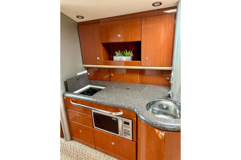  Yacht Photos Pics Luxurious 2007 Formula 400 Super Sport yacht kitchen with wood cabinetry and modern appliances.