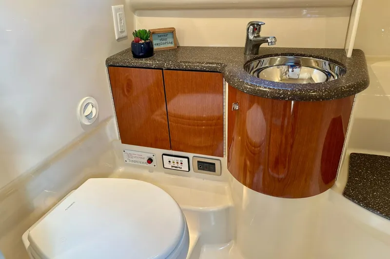  Yacht Photos Pics 2007 Formula 400 Super Sport bathroom with wood cabinetry, sink, and toilet.