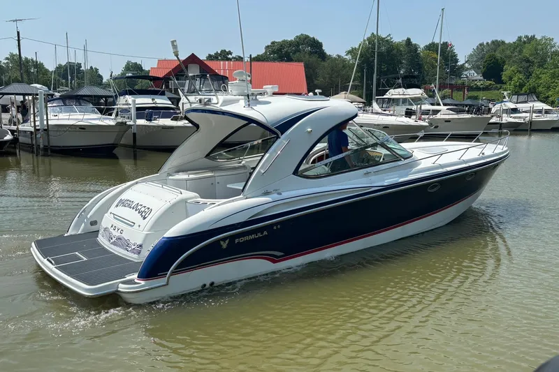  Yacht Photos Pics 2007 Formula 400 Super Sport boat docked in a marina, surrounded by other vessels.