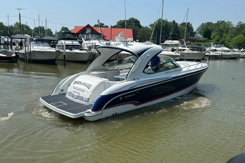  Yacht Photos Pics 2007 Formula 400 Super Sport boat docked in a marina, surrounded by other vessels.