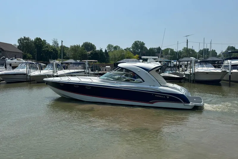  Yacht Photos Pics 2007 Formula 400 Super Sport boat cruising in a marina with other boats docked nearby.