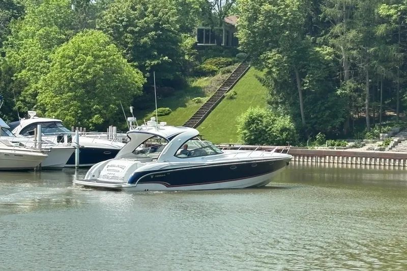 Yacht Photos Pics 2007 Formula 400 Super Sport boat docked on a serene lake with lush greenery.