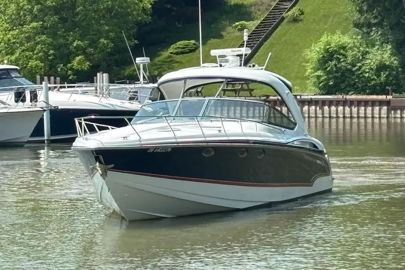  Yacht Photos Pics 2007 Formula 400 Super Sport boat cruising on a calm river near a marina.