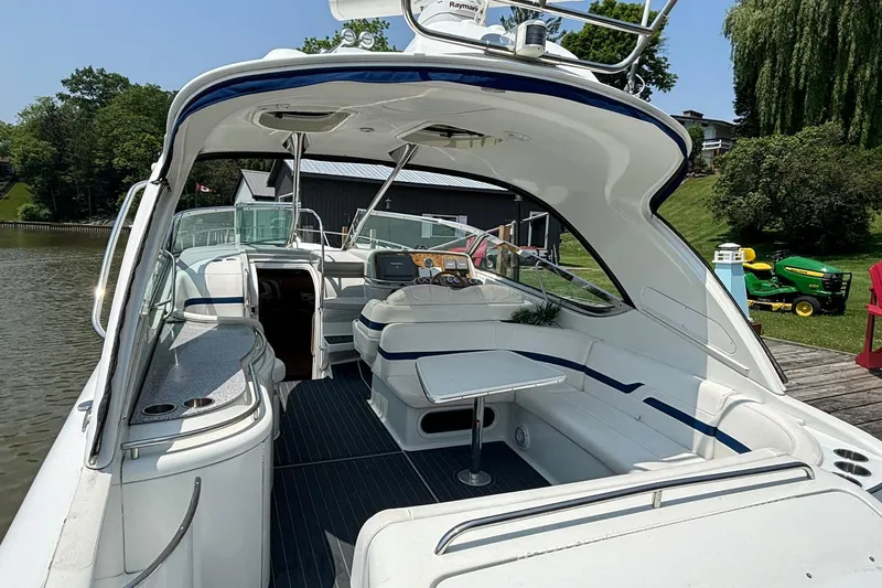  Yacht Photos Pics 2007 Formula 400 Super Sport boat interior with seating and table, docked by a scenic lakeside.