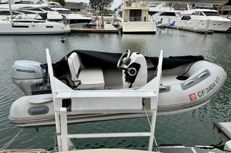  Yacht Photos Pics Inflatable boat with Honda motor docked near luxury yachts, Meridian 391 Sedan, 2014 model.