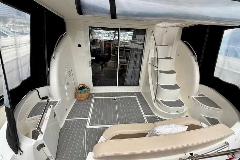  Yacht Photos Pics 2014 Meridian 391 Sedan yacht interior with spiral staircase and seating area.