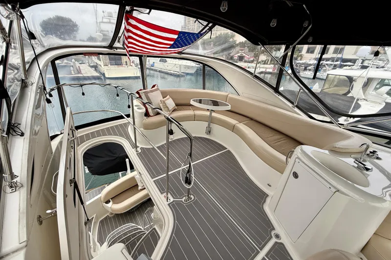  Yacht Photos Pics 2014 Meridian 391 Sedan yacht interior with seating, table, and American flag.