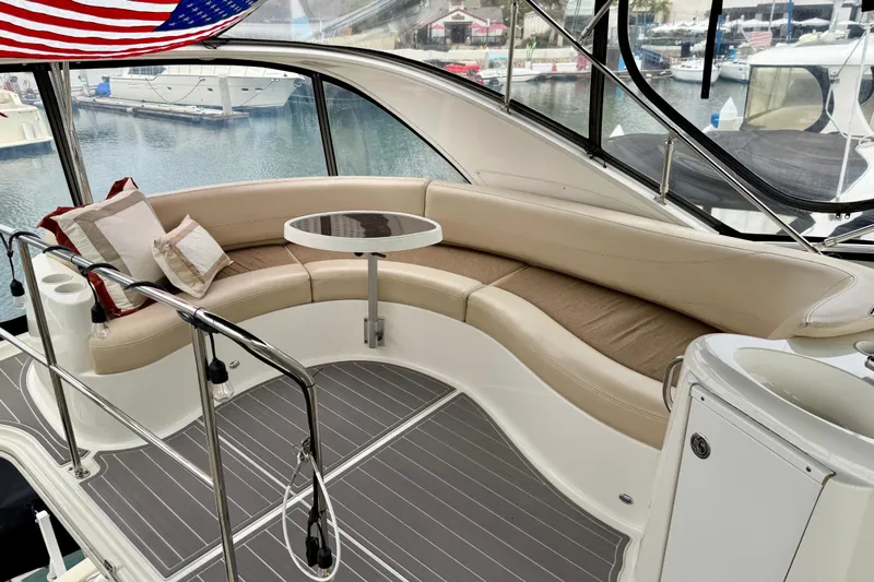  Yacht Photos Pics Luxurious 2014 Meridian 391 Sedan yacht interior with curved seating and table.