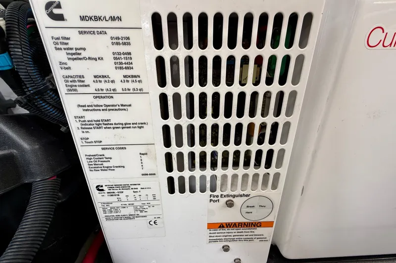  Yacht Photos Pics Engine compartment of a 2014 Meridian 391 Sedan with service data and warning labels.