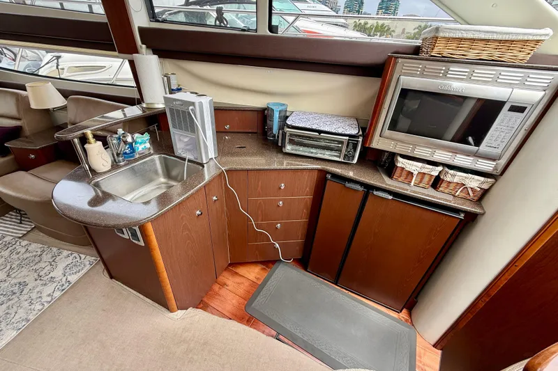  Yacht Photos Pics 2014 Meridian 391 Sedan yacht kitchen with sink, microwave, and storage cabinets.
