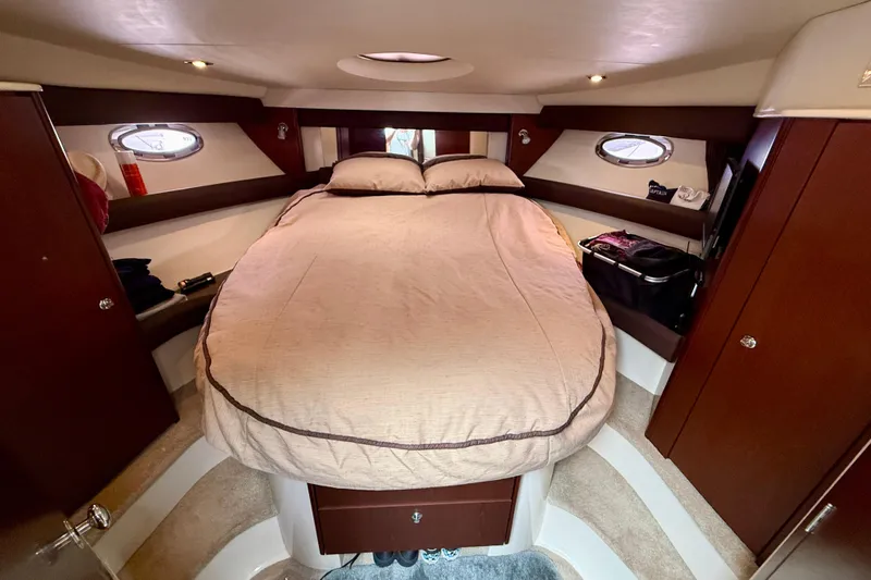 Yacht Photos Pics Luxurious cabin interior of 2014 Meridian 391 Sedan yacht with cozy bed and elegant wood finish.