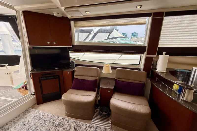  Yacht Photos Pics Luxurious interior of 2014 Meridian 391 Sedan yacht with seating, TV, and window view.