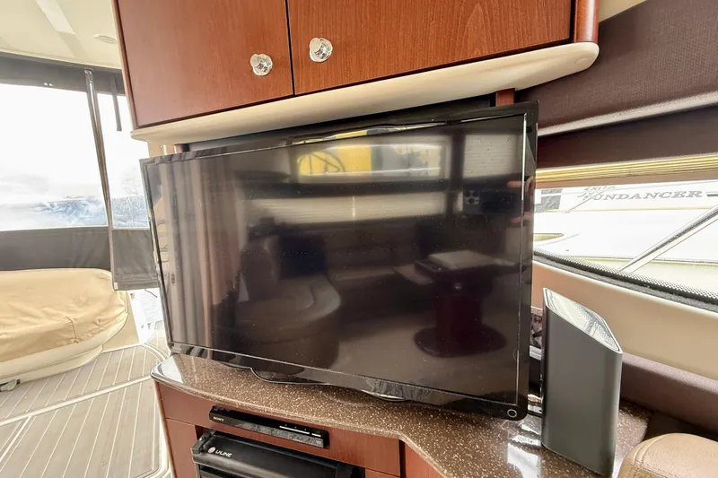  Yacht Photos Pics Interior of 2014 Meridian 391 Sedan with TV and wooden cabinetry.