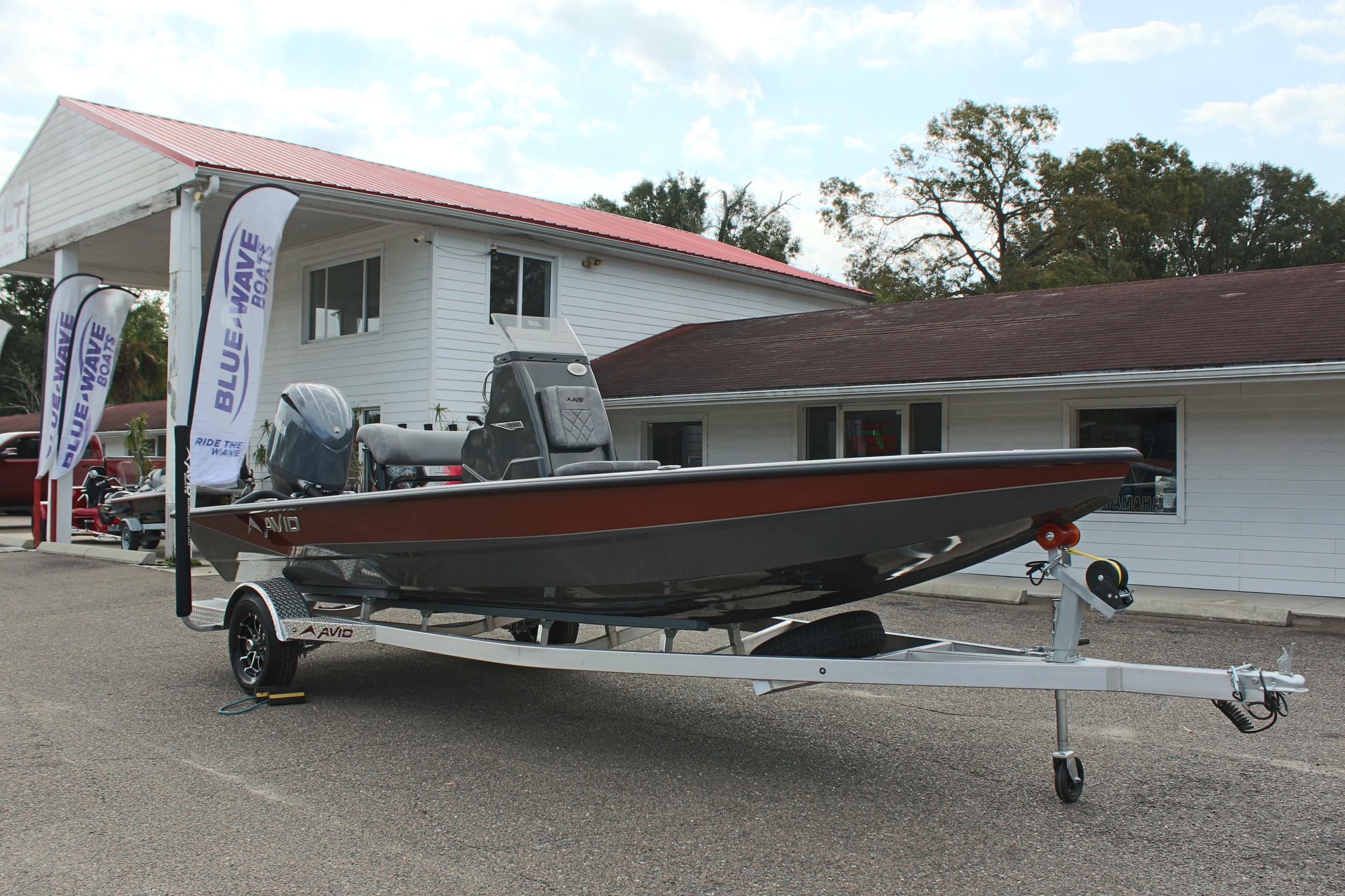 2025 Avid 21 FSX boat on trailer outside dealership.