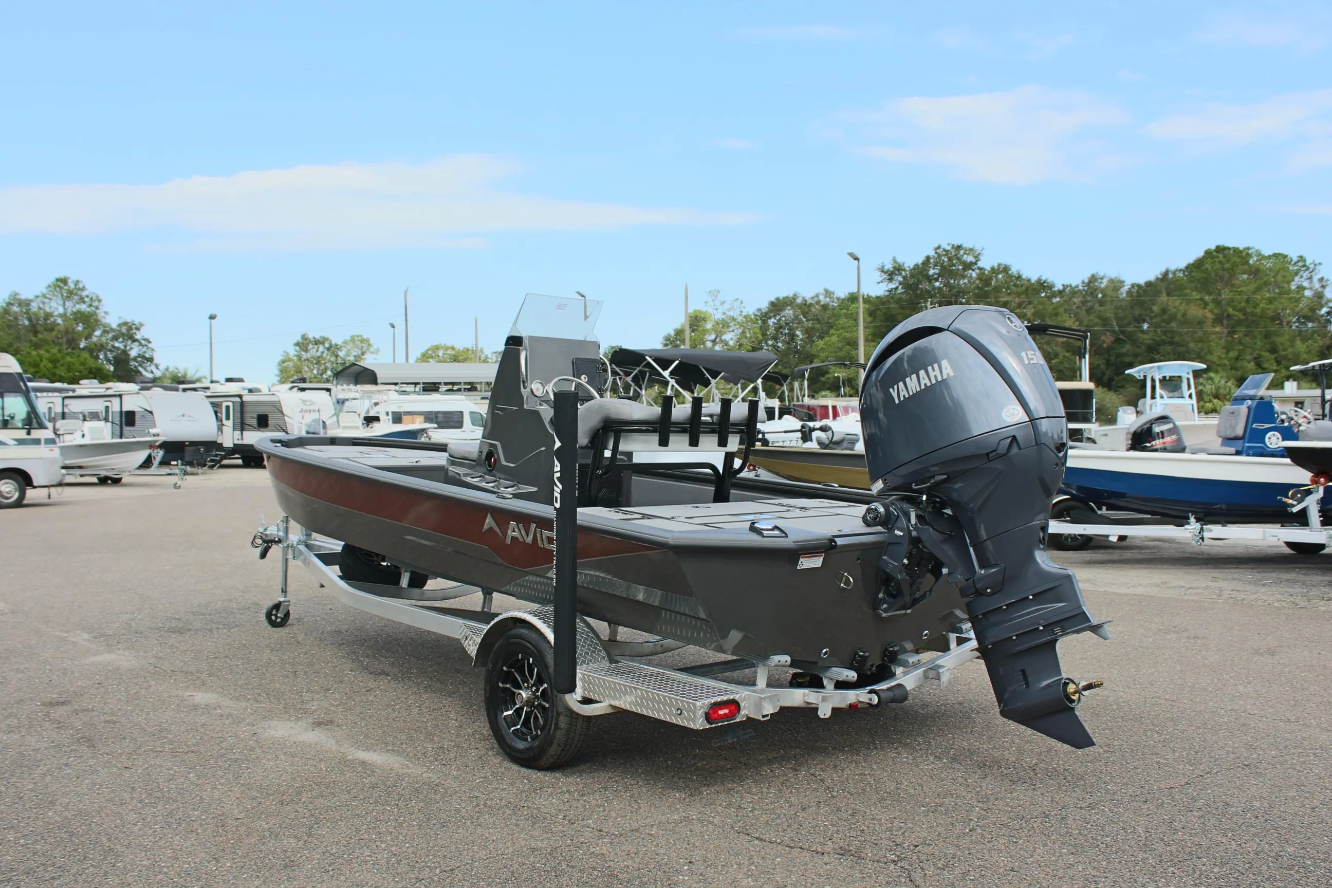 2025 Avid 21 FSX boat with Yamaha motor on trailer in parking lot.